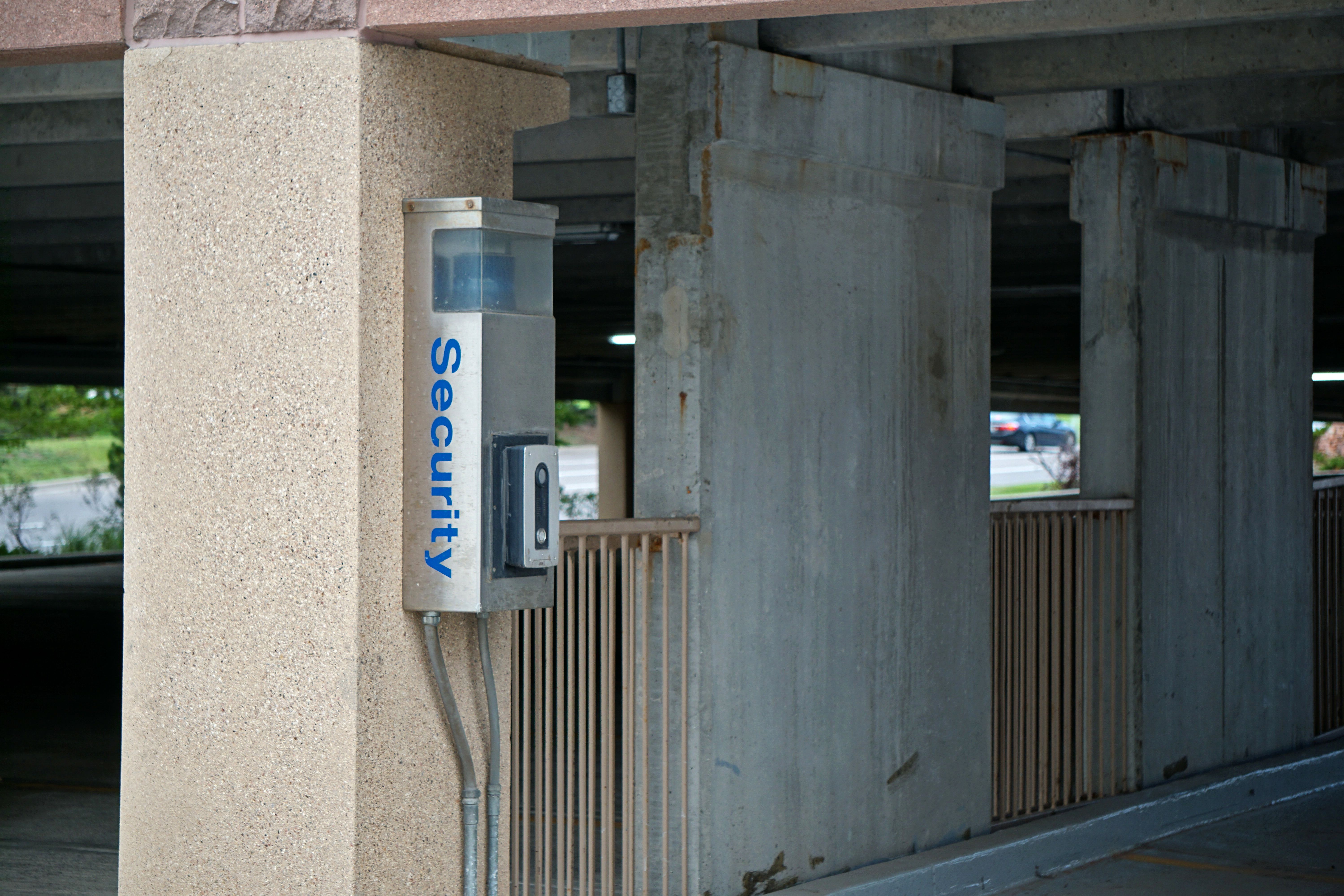 Access-control intercom and camera unit mounted on a structural column in a parking garage